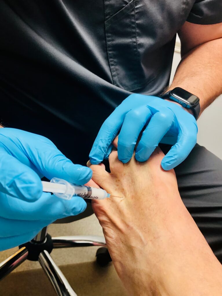 at the doctors patient getting a shot in his foot 2024 12 05 05 06 50 utc
